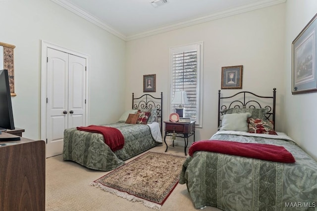 carpeted bedroom featuring a closet, visible vents, and crown molding