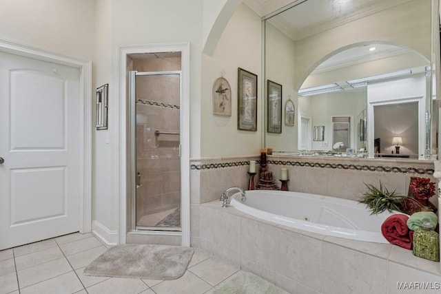 bathroom with crown molding, tile patterned flooring, a bath, and a shower stall