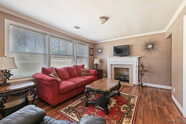 living room featuring dark hardwood / wood-style floors, crown molding, and a brick fireplace