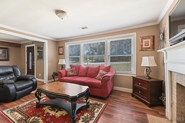 living room with dark wood-type flooring, ornamental molding, and a high end fireplace