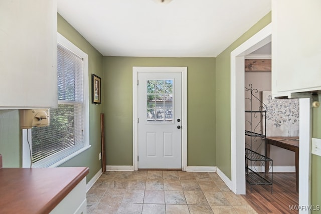 doorway to outside featuring light tile patterned floors