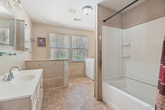 bathroom featuring washer / dryer, vanity, shower / tub combo, and tile patterned floors