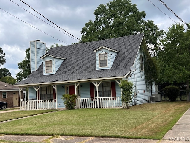 view of front of home featuring a porch, central air condition unit, and a front yard