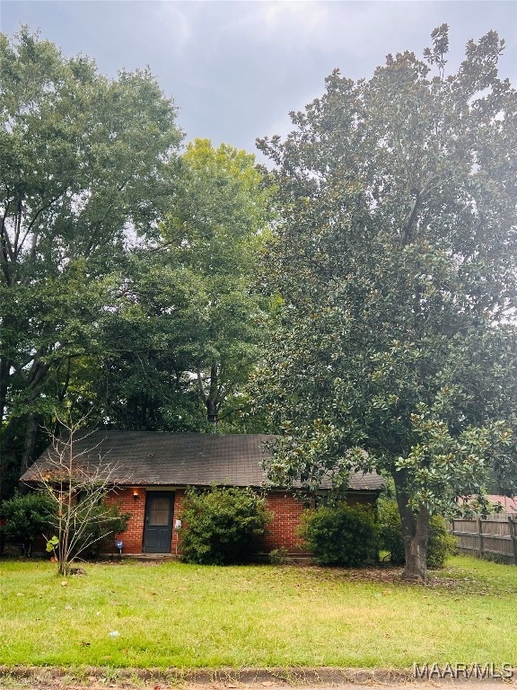 view of side of home with a lawn