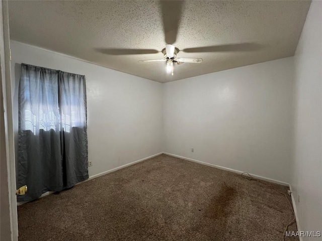 spare room with ceiling fan, carpet flooring, and a textured ceiling