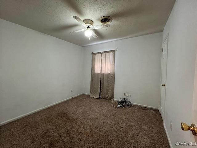 empty room featuring ceiling fan, carpet flooring, and a textured ceiling