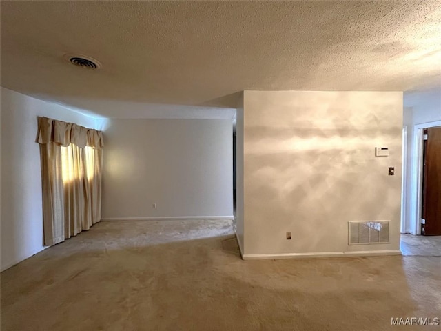 carpeted spare room featuring a textured ceiling