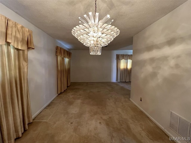 interior space with carpet, a notable chandelier, and a textured ceiling