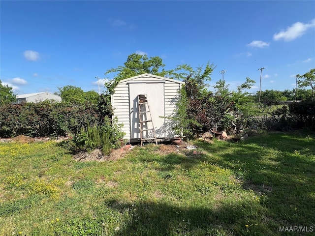 view of outbuilding featuring a lawn