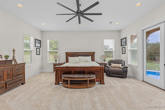 carpeted bedroom with ceiling fan, multiple windows, and access to exterior