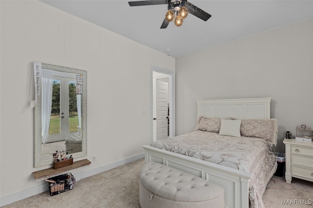 carpeted bedroom with ceiling fan and french doors