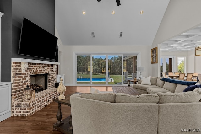 living room with high vaulted ceiling, a fireplace, beam ceiling, dark hardwood / wood-style floors, and ceiling fan