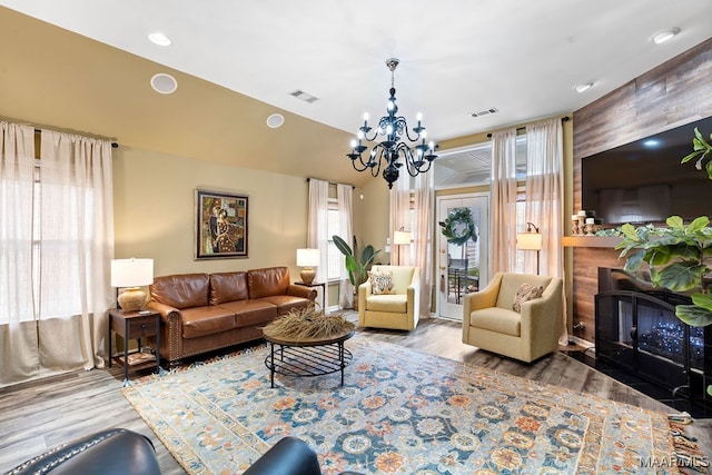 living room with an inviting chandelier and wood-type flooring