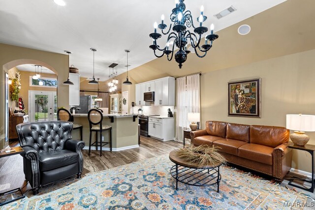 living room featuring a notable chandelier and light hardwood / wood-style floors