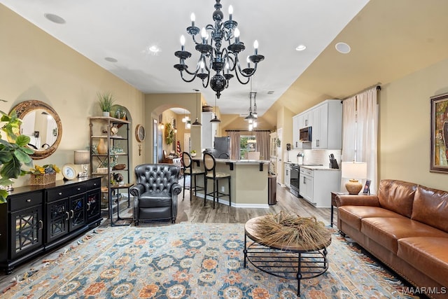 living room featuring light hardwood / wood-style floors and a chandelier