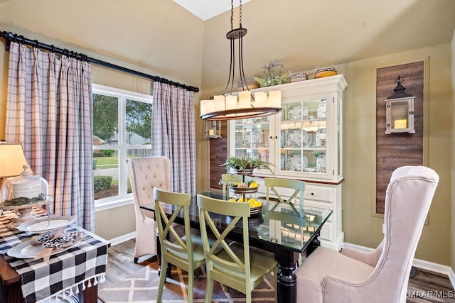 dining space featuring lofted ceiling and light wood-type flooring