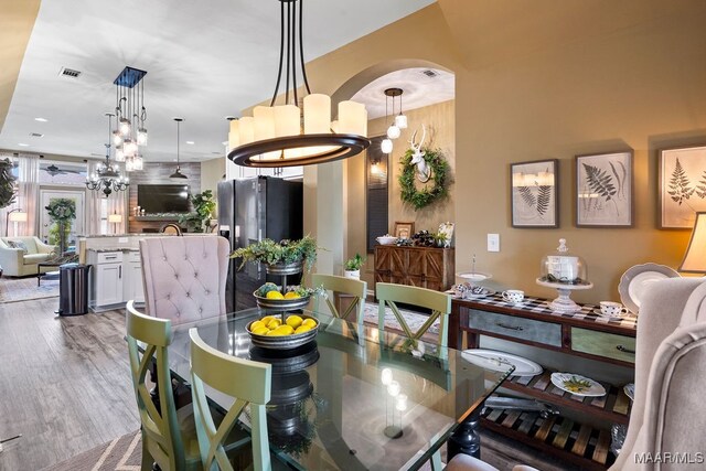 dining room featuring light wood-type flooring and an inviting chandelier