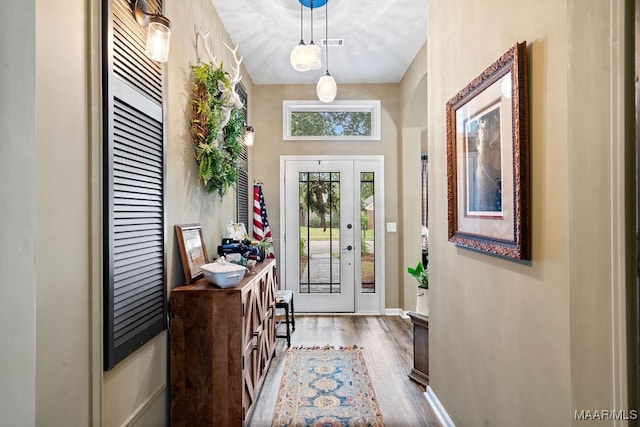 doorway with hardwood / wood-style floors