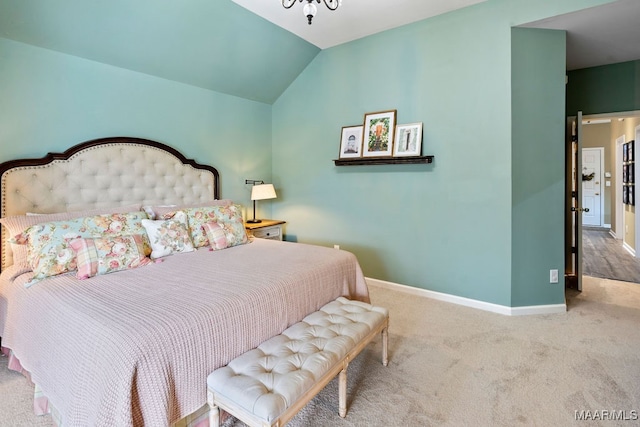 carpeted bedroom featuring lofted ceiling