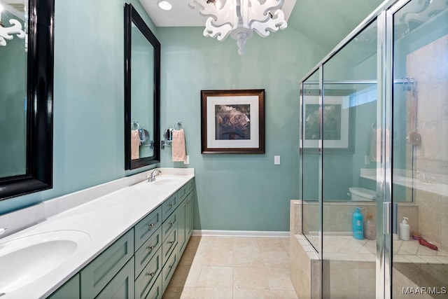 bathroom featuring a shower with shower door, a chandelier, vanity, and tile patterned floors