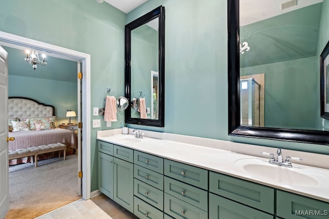 bathroom featuring a shower with shower door, tile patterned flooring, and vanity