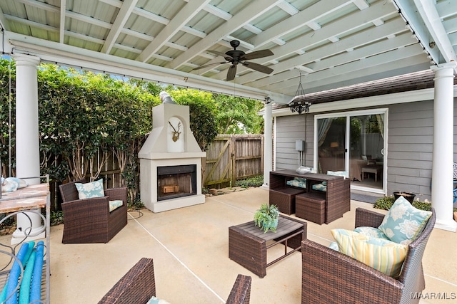 view of patio featuring ceiling fan and an outdoor living space with a fireplace