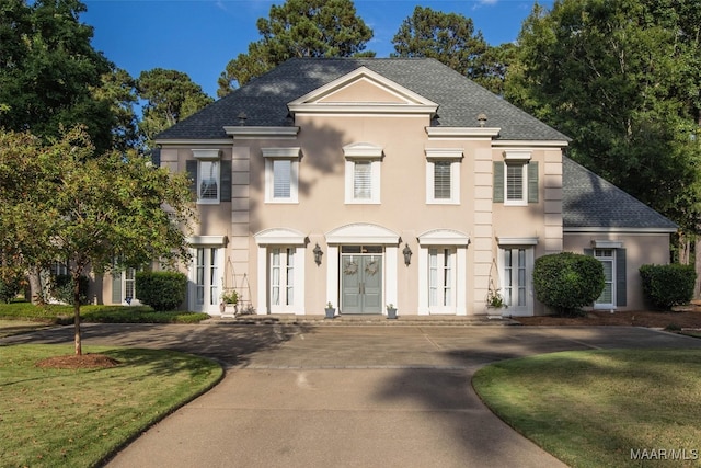 view of front of home with french doors and a front yard