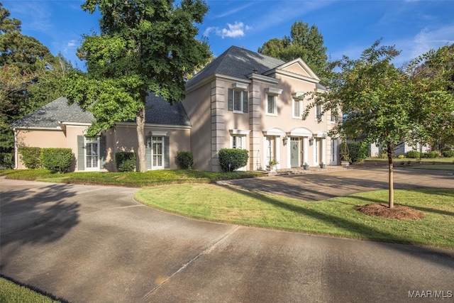 view of front of property featuring a garage and a front lawn