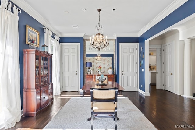 dining area with crown molding, dark hardwood / wood-style floors, and an inviting chandelier