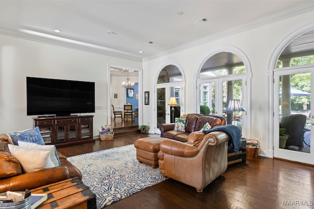 living room with ornamental molding, french doors, an inviting chandelier, and dark hardwood / wood-style floors