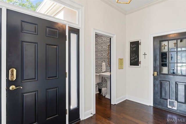 foyer with ornamental molding and dark hardwood / wood-style floors