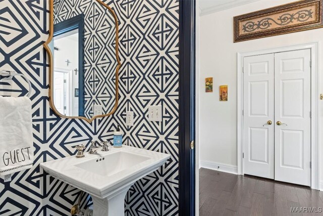 bathroom featuring wood-type flooring and ornamental molding