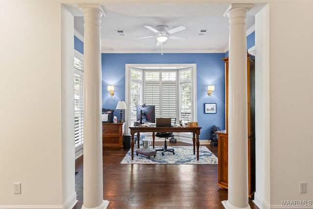 office space featuring crown molding, ceiling fan, dark hardwood / wood-style flooring, and decorative columns