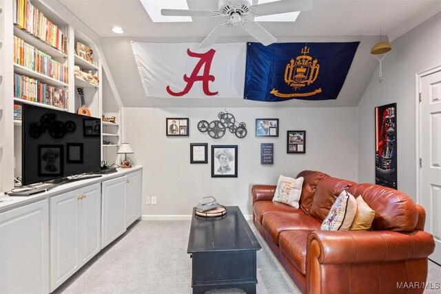 living room featuring built in shelves, light colored carpet, ceiling fan, and lofted ceiling with skylight