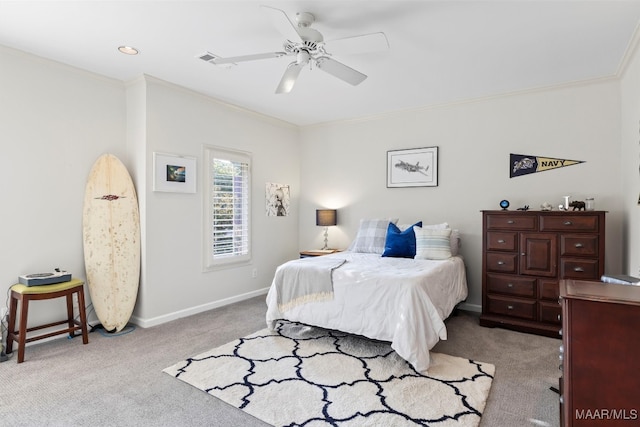 bedroom with light carpet, ornamental molding, and ceiling fan