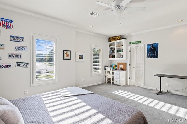 carpeted bedroom with ceiling fan, ornamental molding, and multiple windows