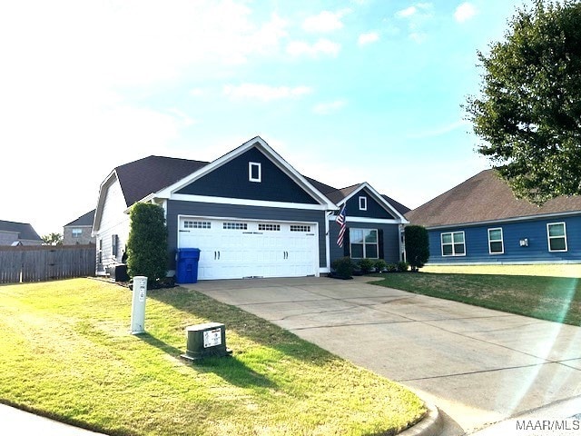 view of front of property featuring a garage and a front lawn