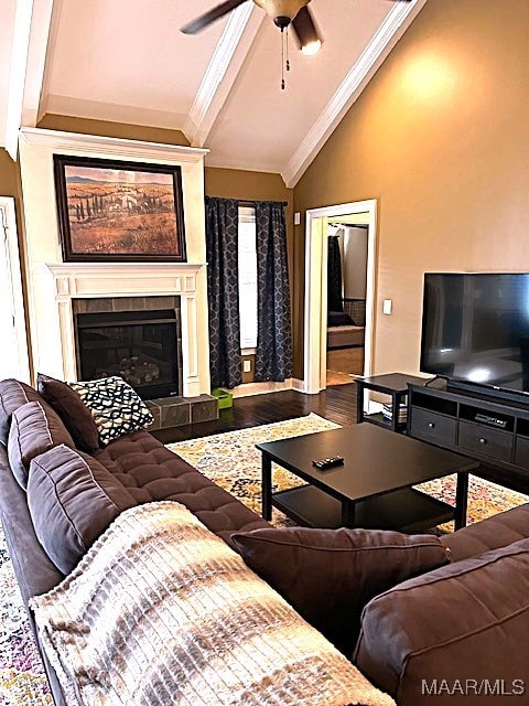 living room with a fireplace, high vaulted ceiling, ornamental molding, wood-type flooring, and ceiling fan