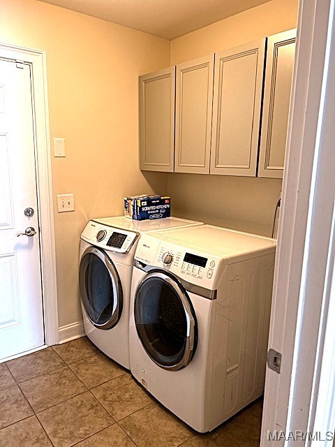 laundry room with cabinets, independent washer and dryer, and light tile patterned flooring