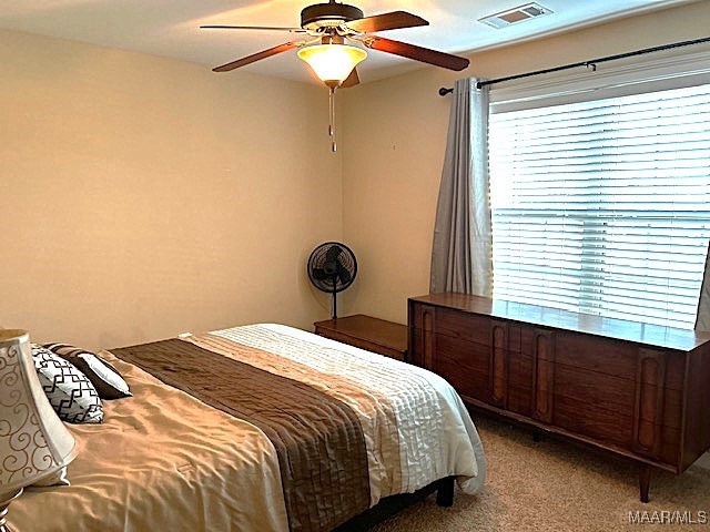 bedroom with ceiling fan and carpet floors