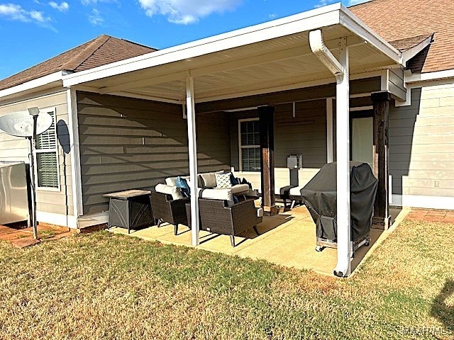 back of property featuring a lawn and an outdoor hangout area