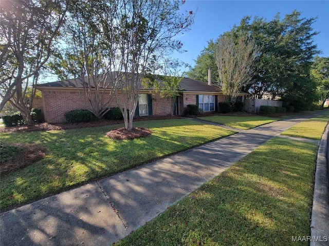 ranch-style house featuring a front lawn