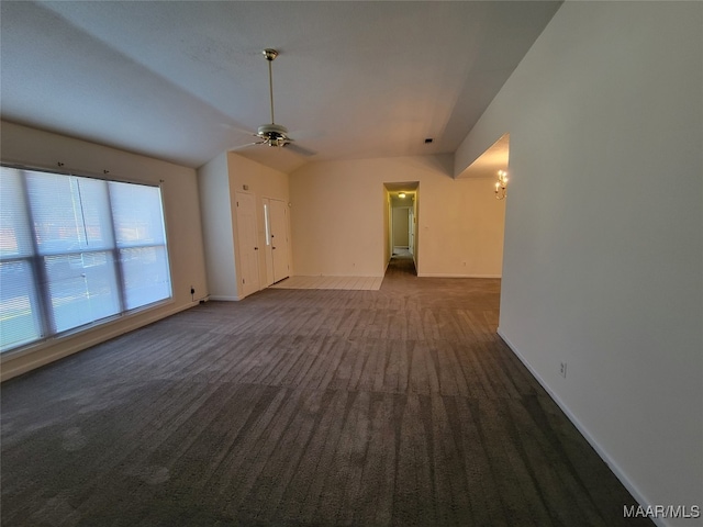 carpeted empty room with ceiling fan and vaulted ceiling