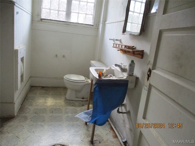 bathroom with toilet and tile patterned floors