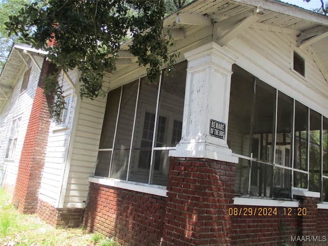 view of home's exterior with a sunroom