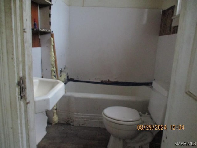 bathroom with a bathing tub and toilet