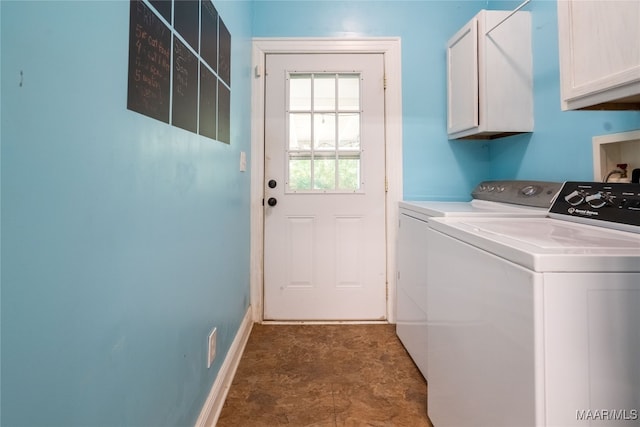 washroom featuring cabinets and separate washer and dryer