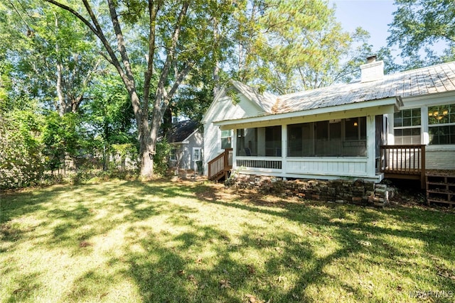 exterior space featuring a sunroom