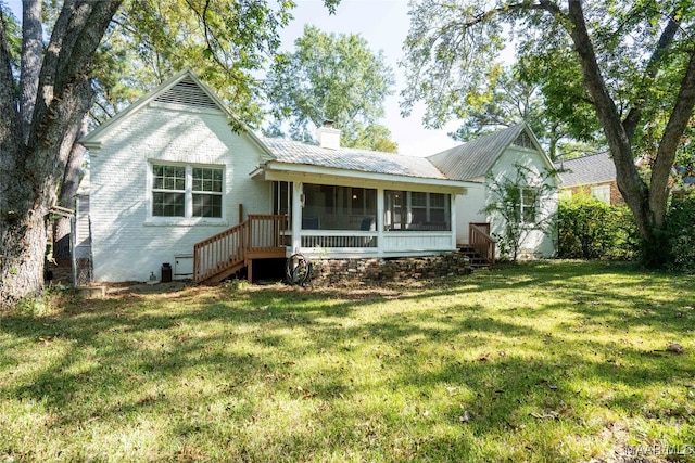 single story home featuring a sunroom and a front lawn