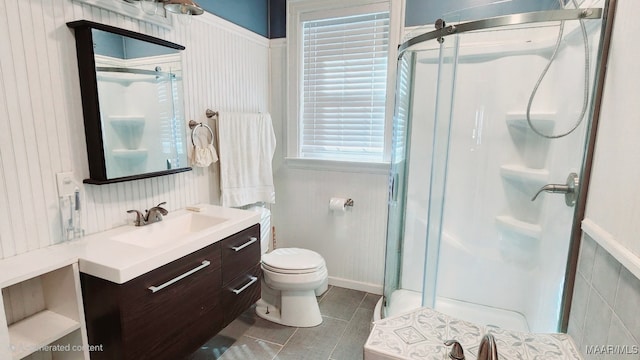 bathroom featuring vanity, walk in shower, and toilet